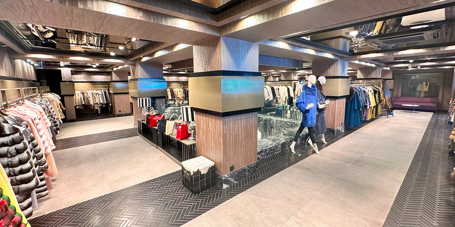 The image serves as a guide on where to find fur leather wool istanbul featuring the interior of Mahal Hasan Store. You can see a variety of combined material garments displayed including items made from authentic natural fibers like cashmere and mink. The photo highlights our location in the zeytinburnu shopping district as a premier destination for luxury shopping. A display of the seasonal collection showcase for 2026 is visible in the background. This visual confirms that you can find fur leather wool istanbul of the highest quality in our showroom.