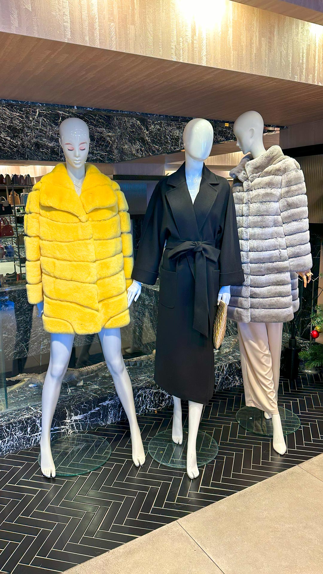 The image features the new 2026 collection at our womens luxury fur boutique in Istanbul showcasing a variety of elite fur varieties. A model is wearing a full-length sable coat from our rare pelt selection which highlights the feminine outerwear silhouettes of the season. The display emphasizes the elegant coat shapes and the detailed artisan fur tailoring that defines our brand. You can see the precision of our master furrier work in the seamless construction of the collar and sleeves. The collection reflects the latest modern glamour trends and a sophisticated contemporary winter style for women. This visual guide helps shoppers visualize the quality available at our womens luxury fur boutique. Each piece demonstrates the beauty of our elite fur varieties and the skill involved in our artisan fur tailoring.