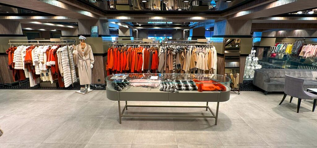 The image features the new 2026 collection at our womens luxury fur boutique in Istanbul showcasing a variety of elite fur varieties. A model is wearing a full-length sable coat from our rare pelt selection which highlights the feminine outerwear silhouettes of the season. The display emphasizes the elegant coat shapes and the detailed artisan fur tailoring that defines our brand. You can see the precision of our master furrier work in the seamless construction of the collar and sleeves. The collection reflects the latest modern glamour trends and a sophisticated contemporary winter style for women. This visual guide helps shoppers visualize the quality available at our womens luxury fur boutique. Each piece demonstrates the beauty of our elite fur varieties and the skill involved in our artisan fur tailoring.