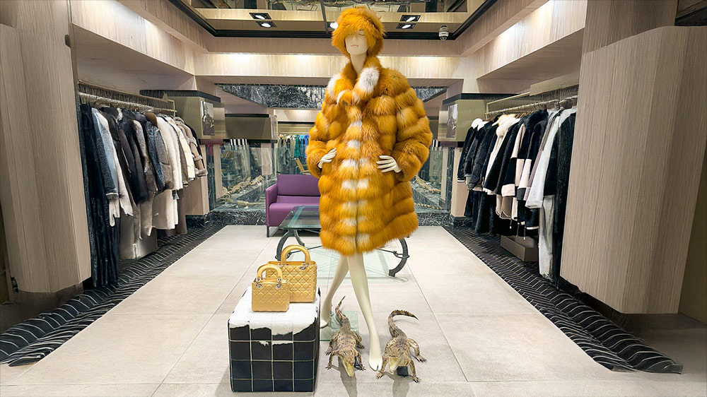 The image features the new 2026 collection at our womens luxury fur boutique in Istanbul showcasing a variety of elite fur varieties. A model is wearing a full-length sable coat from our rare pelt selection which highlights the feminine outerwear silhouettes of the season. The display emphasizes the elegant coat shapes and the detailed artisan fur tailoring that defines our brand. You can see the precision of our master furrier work in the seamless construction of the collar and sleeves. The collection reflects the latest modern glamour trends and a sophisticated contemporary winter style for women. This visual guide helps shoppers visualize the quality available at our womens luxury fur boutique. Each piece demonstrates the beauty of our elite fur varieties and the skill involved in our artisan fur tailoring.